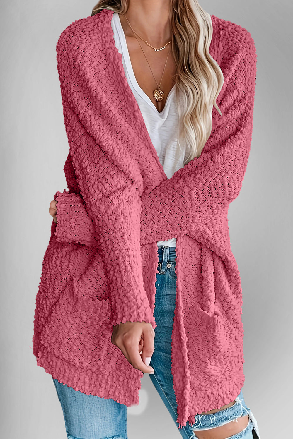 Deep Rose popcorn knit open cardigan with pockets, styled with a white v-neck top and jeans.