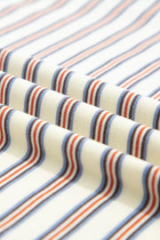 Cotton striped mini dress with blue, orange, and brown stripes on a cream background.