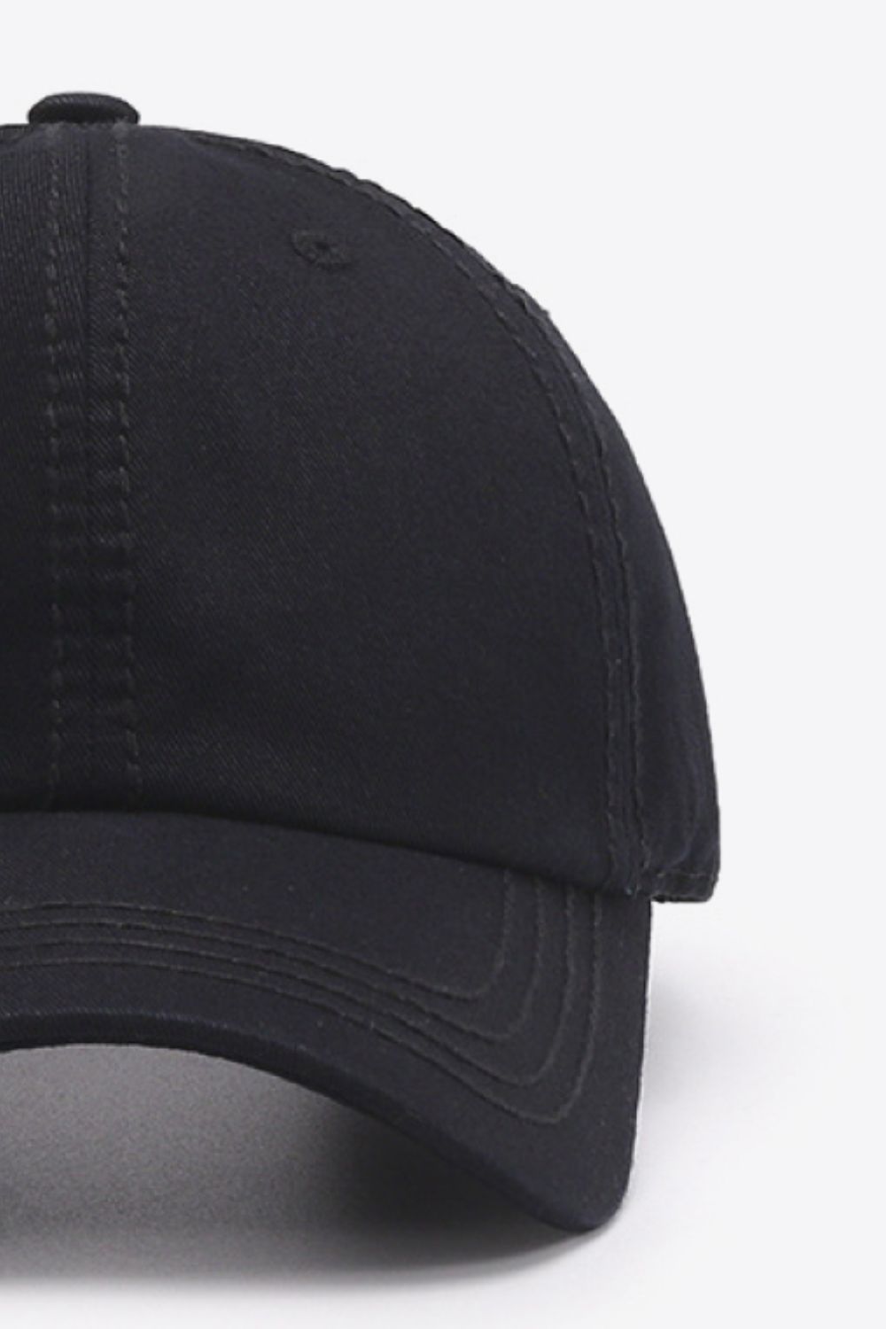 Black canvas baseball cap with stitched details and curved brim.