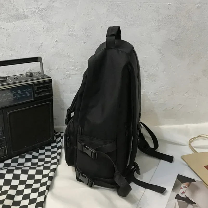Black utility buckle backpack with multiple pockets and adjustable straps.