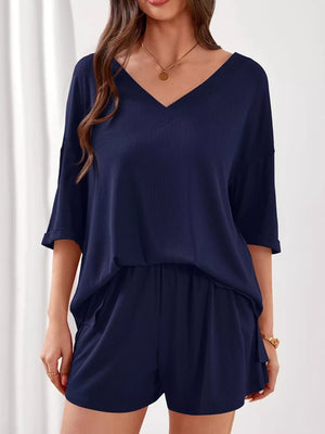 Navy V-neck loungewear set with cuffed sleeves and elastic waist shorts.