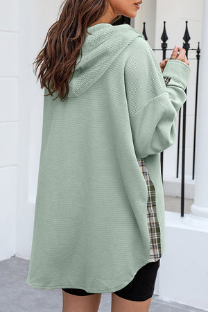Sage waffle knit shacket with plaid trim detail and hood, styled casually.