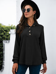 Black waffle knit long sleeve tee with button neckline and collar detail.