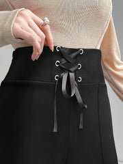 Black lace-up waist flare trousers with a corset detail and silver grommets.