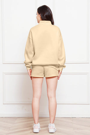 Caramel quarter-zip loungewear set with shorts and a mock neck sweatshirt.