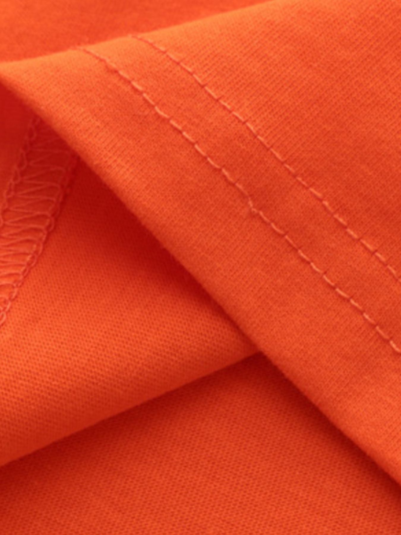 Orange cotton toddler t-shirt with crew neck and short sleeves, showing stitched hem detail.