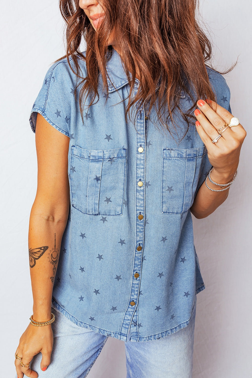 Denim shirt with short sleeves, star print, button-down front, and two chest pockets.