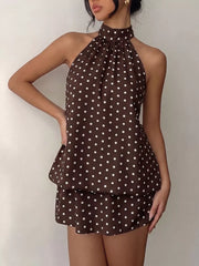 Chic polka dot halter mini dress in coffee brown with a tiered skirt and gathered neckline.