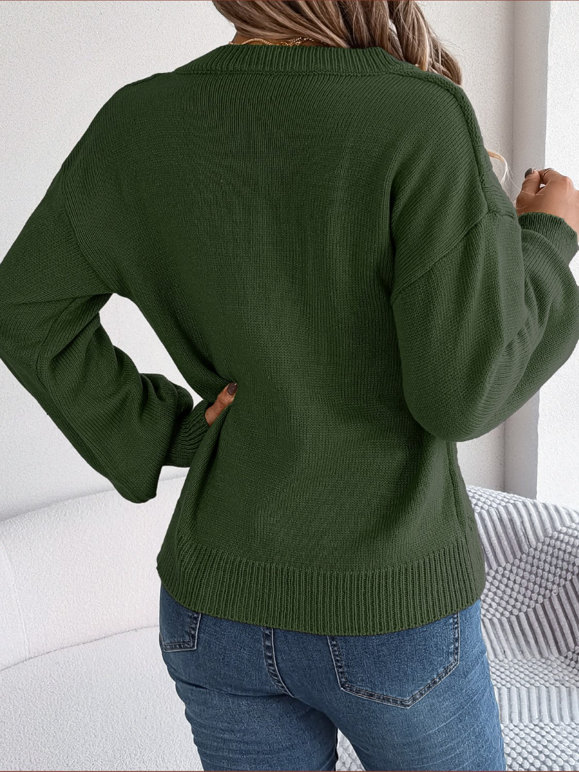 Army green acrylic cable knit button-front cardigan with crew neck and long sleeves.