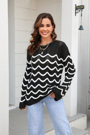Black wavy knit openwork sweater with white wave pattern and crew neck.