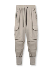 Technical cargo joggers in mocha with ribbed cuffs and zippered pockets.