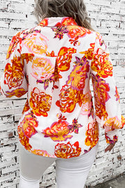 Floral print blouse with blouson sleeves and a collared neckline.