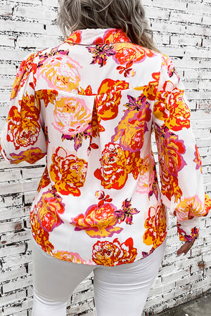 Floral print blouse with blouson sleeves and a collared neckline.