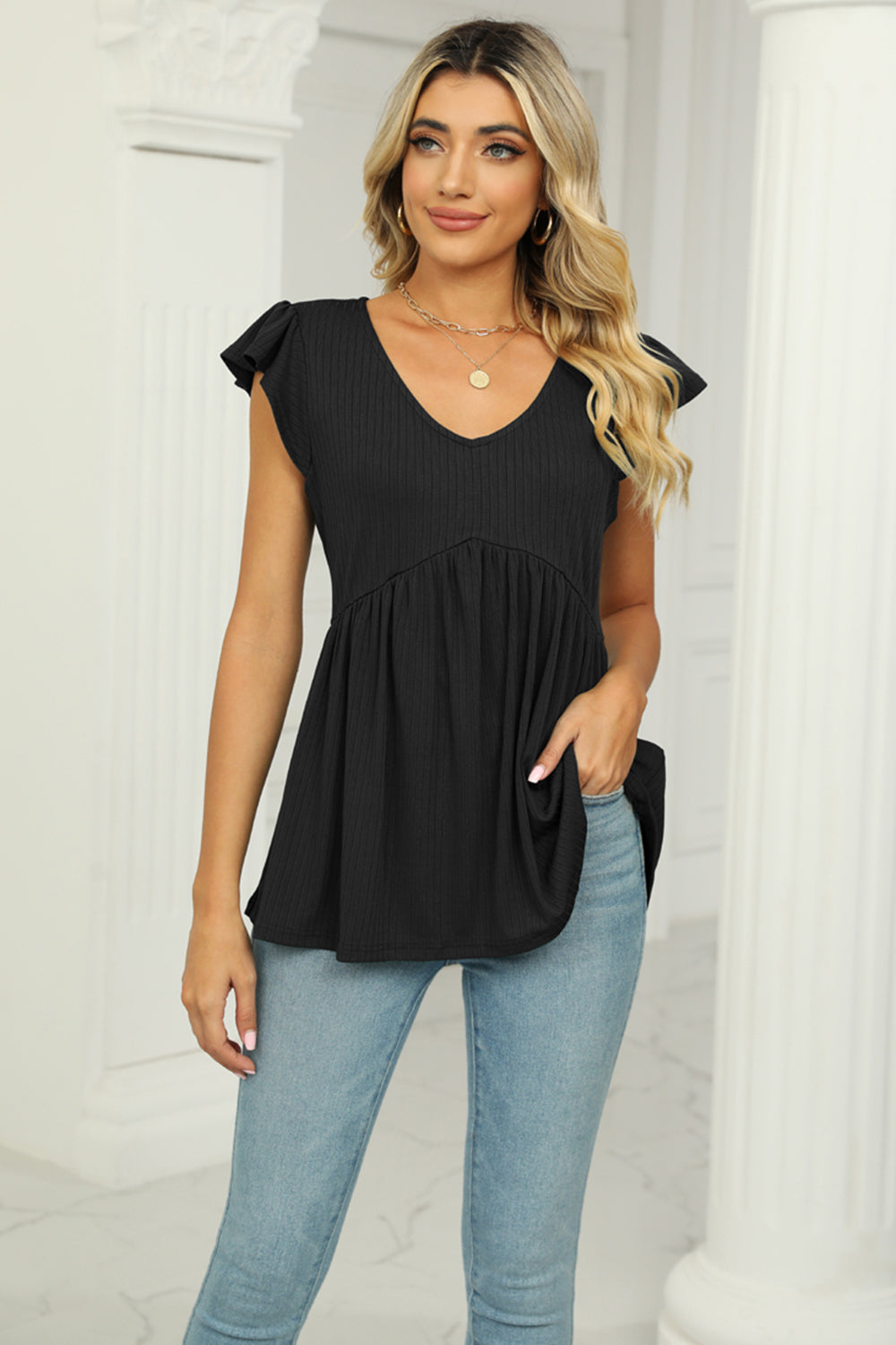 Black ribbed V-neck babydoll top with flutter sleeves and empire waist