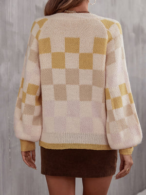 Geometric checkerboard knit sweater with puff sleeves in cream and light yellow.