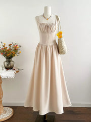 Elegant cream square neck a-line maxi dress with drawstring bust and spaghetti straps.