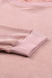 Dusty pink ribbed sweatshirt with textured XOXO appliqué detail.
