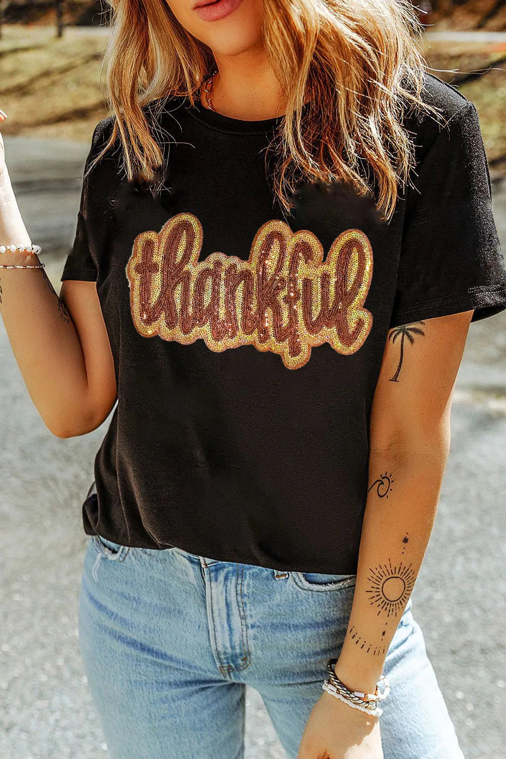 Black cotton tee with sequin "thankful" appliqué and short sleeves.