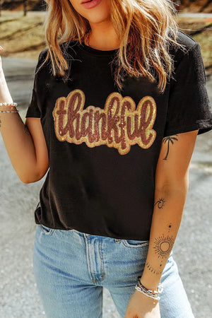 Black cotton tee with sequin "thankful" appliqué and short sleeves.