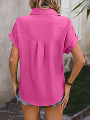 Pink textured button-down shirt with cuffed short sleeves and a relaxed fit.