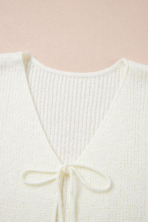 Tie-front textured knit tank top in beige with a V-neckline and ribbed detail.