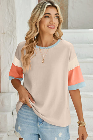 Panel sleeve crewneck tee with color block detail in beige, cream, coral, and light blue.