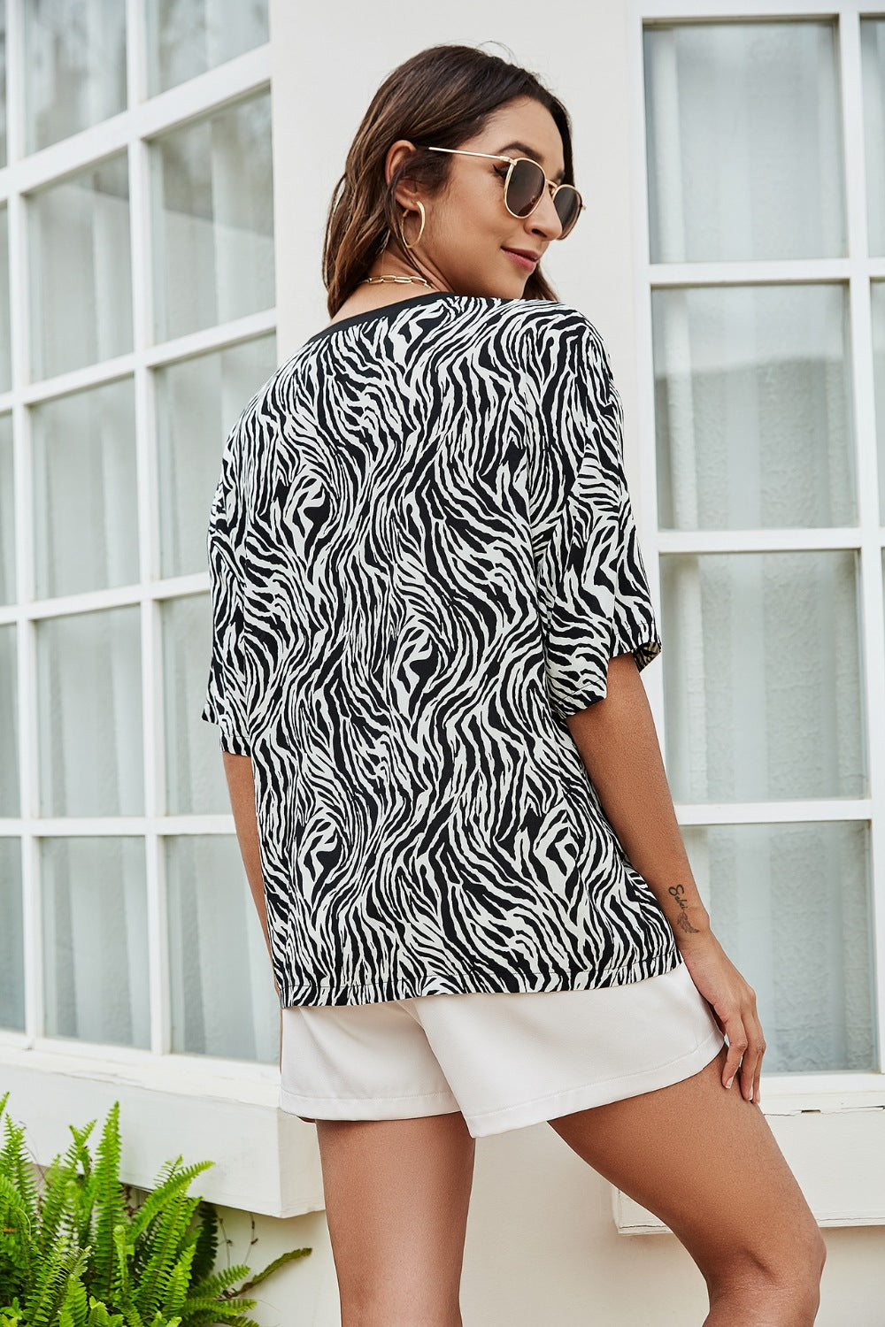 Black and white zebra print boxy tee with short sleeves.