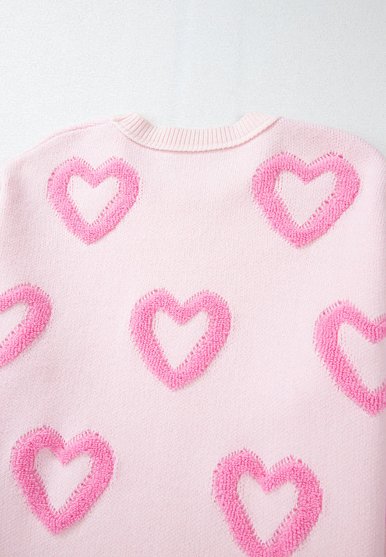 Pink knit sweater with allover textured heart appliqué and balloon sleeves.