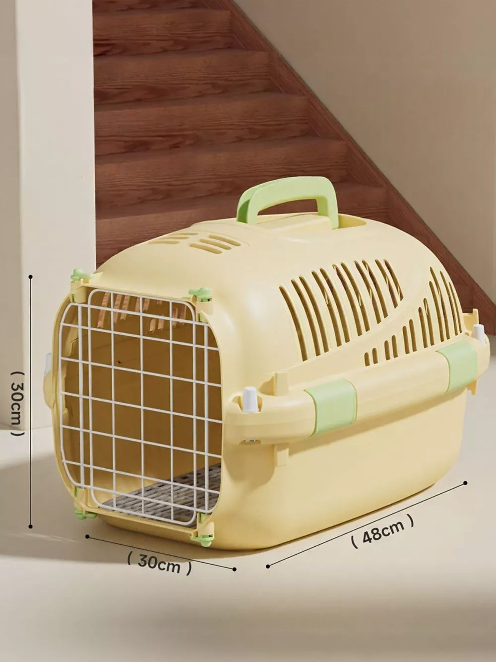 Cheerful ventilated pet carrier bag in pastel yellow with green accents and a secure metal door.