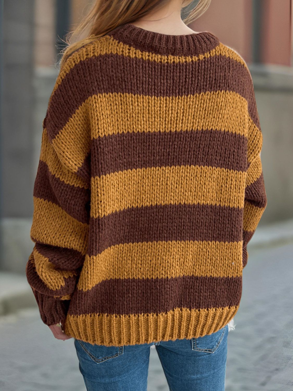 Chunky knit jumper with brown and ochre stripes, crew neck, and ribbed cuffs.