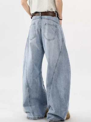 Distressed light blue wide-leg jeans with belt, cotton denim, casual men's style.
