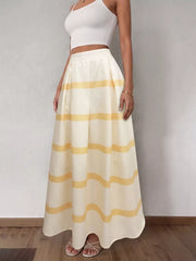Flowy maxi skirt in cream with yellow wavy stripes and pockets.