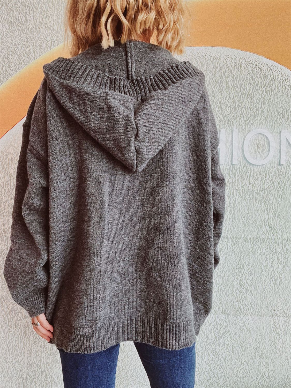 Dark gray chunky knit hooded cardigan with ribbed details and button-down front.