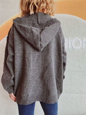 Dark gray chunky knit hooded cardigan with ribbed details and button-down front.