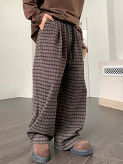 Men's brown plaid wide leg trousers with drawstring waist.