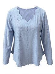 Light blue eyelet blouse with scalloped neckline and long sleeves.