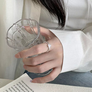 Sleek geometric zircon silver ring with a square-cut stone on a delicate band.