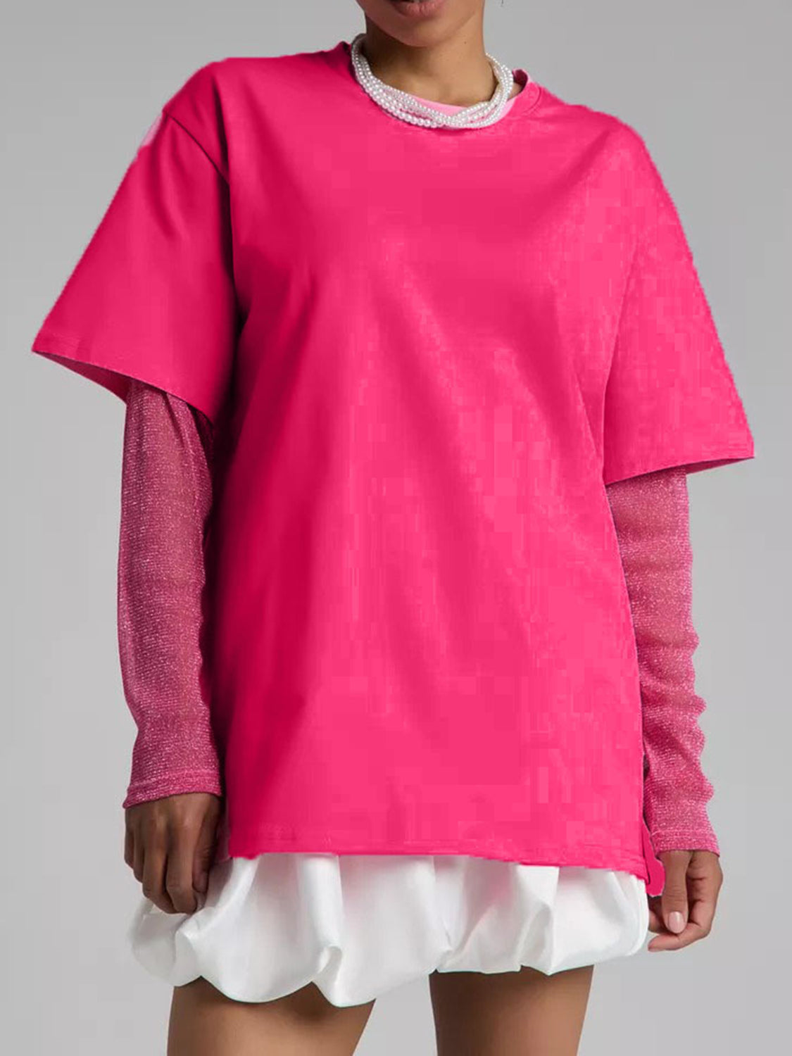 Hot Pink oversized tee with sheer long sleeves and a textured pattern, layered over a white ruffled hem.