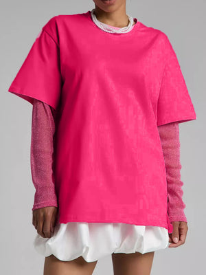Hot Pink oversized tee with sheer long sleeves and a textured pattern, layered over a white ruffled hem.