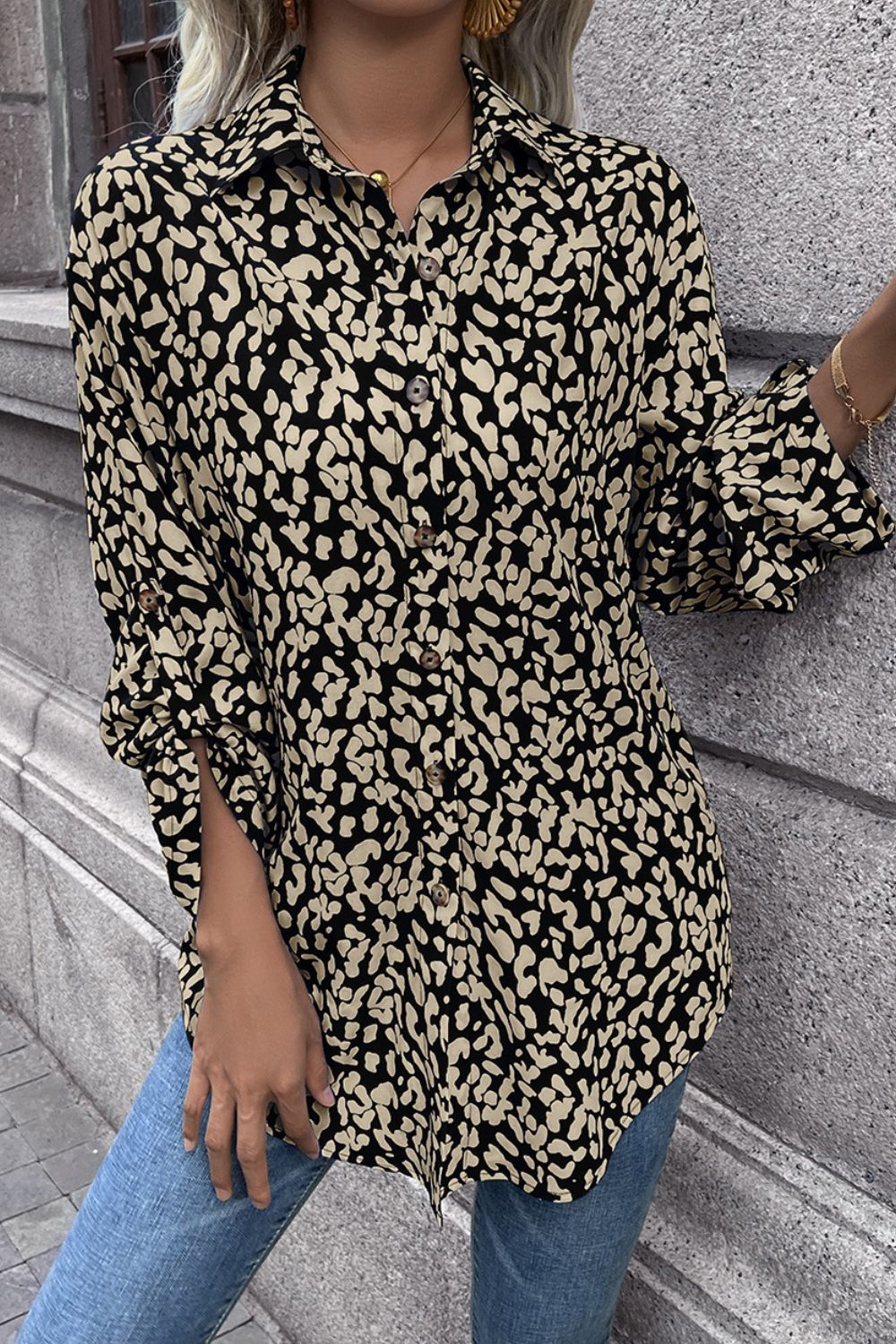 Women's black and beige abstract spot print oversized shirt with button front and rolled sleeves.