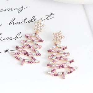 Festive crystal tree dangle earrings with star tops in light green and lilac hues.