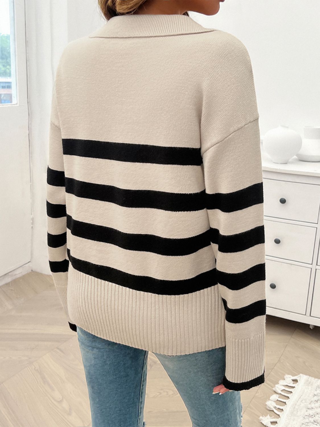 Tan knit sweater with bold black stripes and a collared neckline.