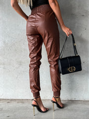 Brown leatherette gathered waist joggers with elastic cuffs and cinched ankles.