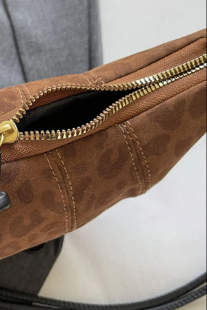 Brown leopard print crescent shoulder bag with gold zipper detail