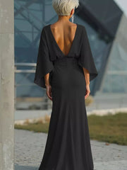 Black batwing sleeve maxi dress with deep V-back and flowing skirt.