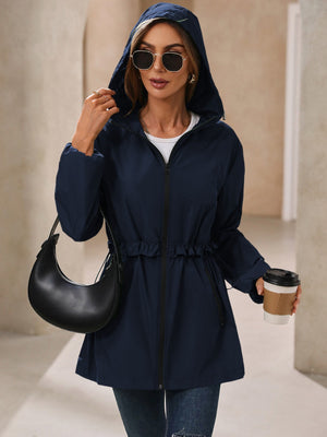 Navy hooded windbreaker jacket with ruffled drawstring waist and zippered front.