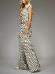 Off-white and black striped crop top with adjustable tie and wide-leg pants.