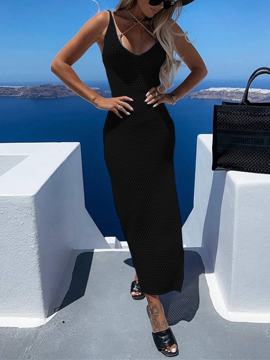 Black open-knit maxi dress with V-neck and spaghetti straps, styled with sandals.
