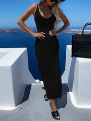 Black open-knit maxi dress with V-neck and spaghetti straps, styled with sandals.