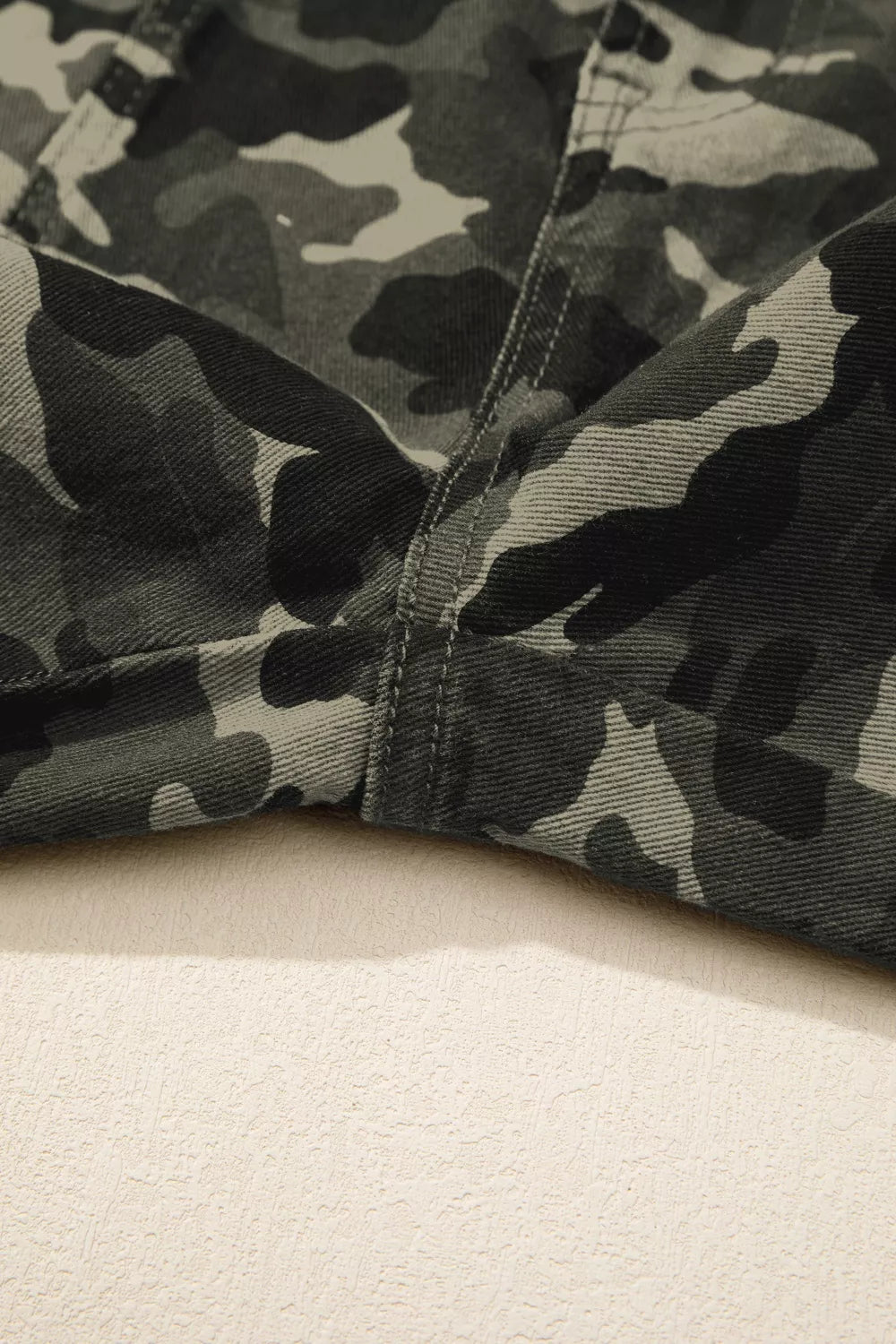 Camo print jeans with detailed stitching and a cotton fabric.